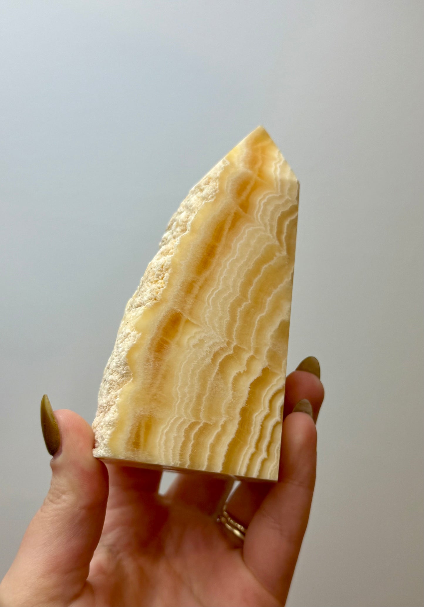 Half raw orange calcite tower