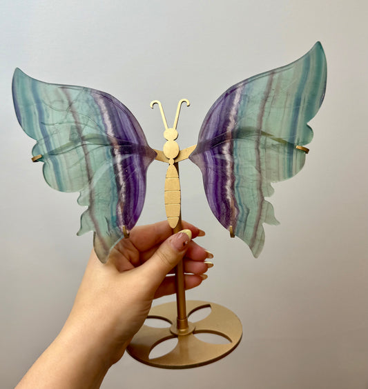 Repaired fluorite butterfly carving on a stand