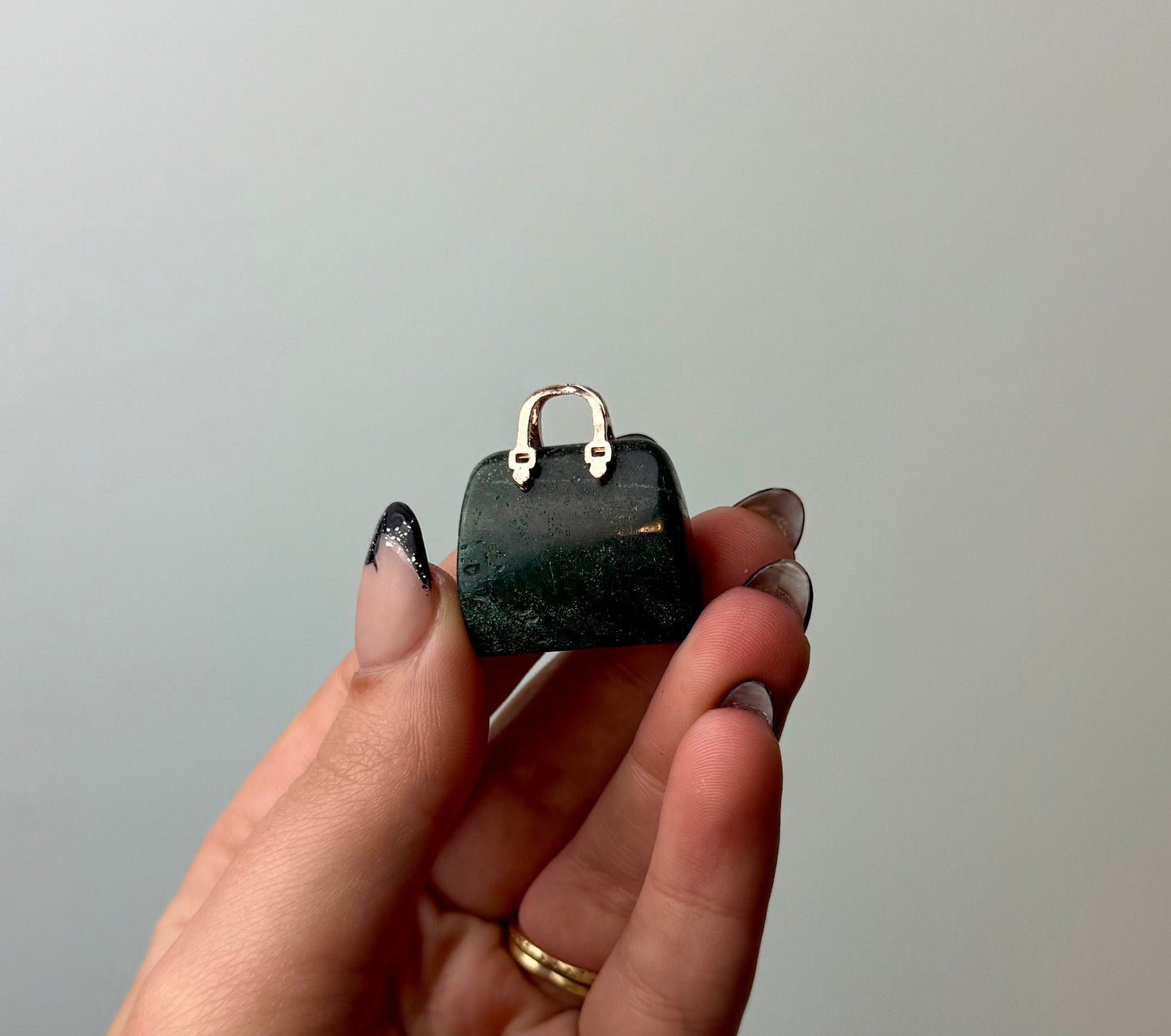 Moss agate purse carving
