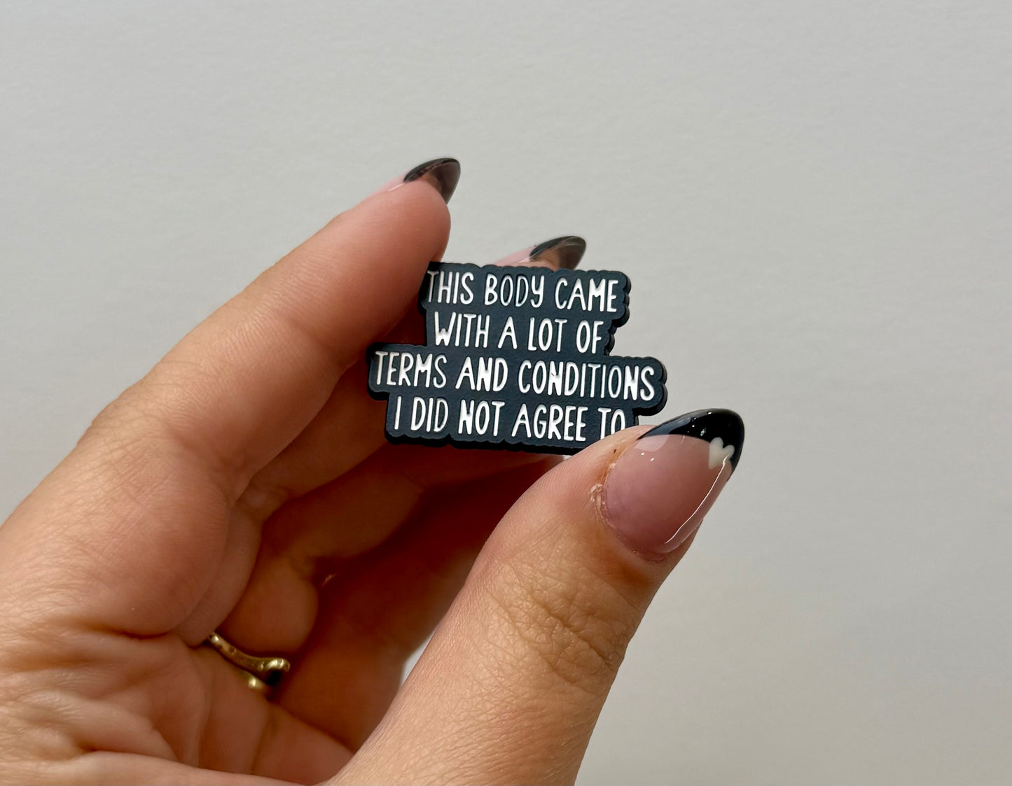 Terms and conditions enamel pin