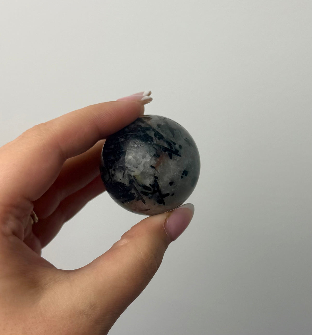 Black tourmaline in quartz sphere