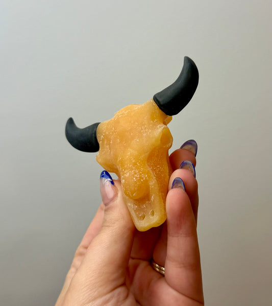 Orange calcite cow skull carving