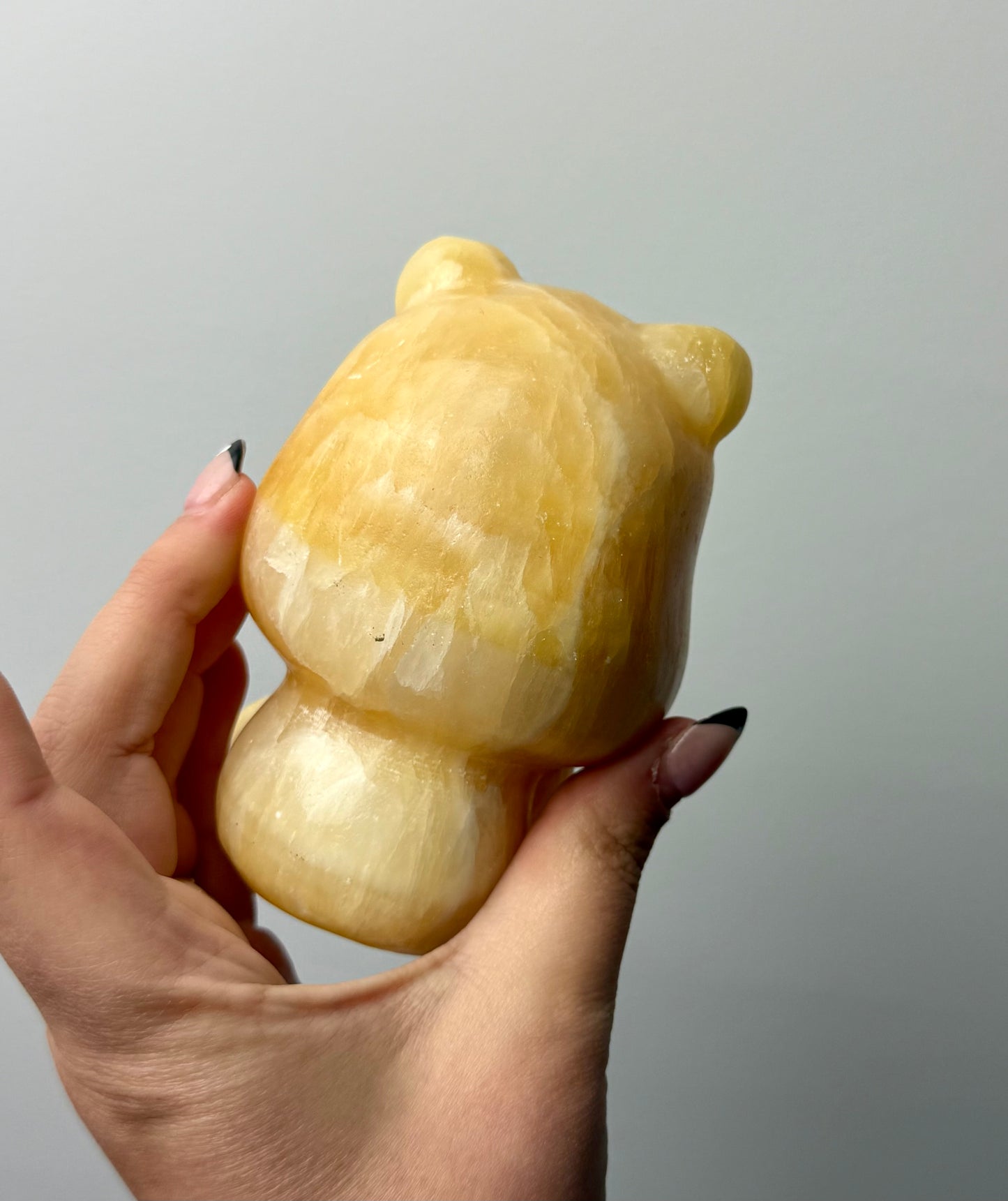 Orange calcite Winne the Pooh carving