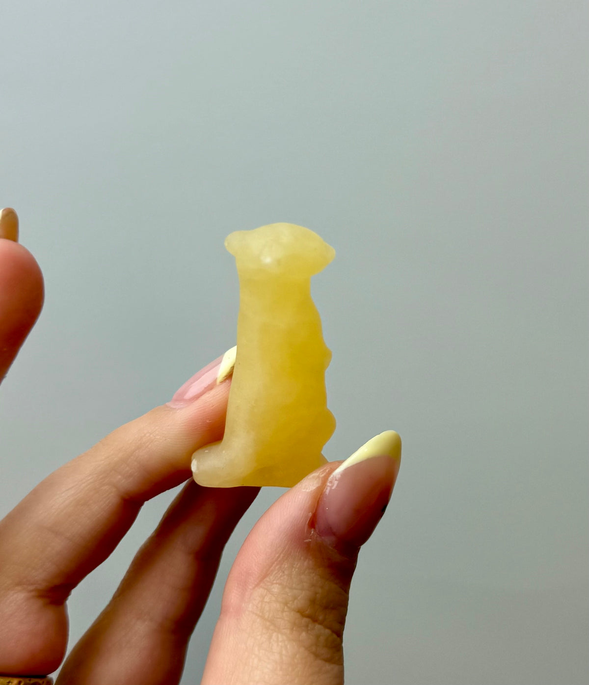 Orange calcite meerkat carving