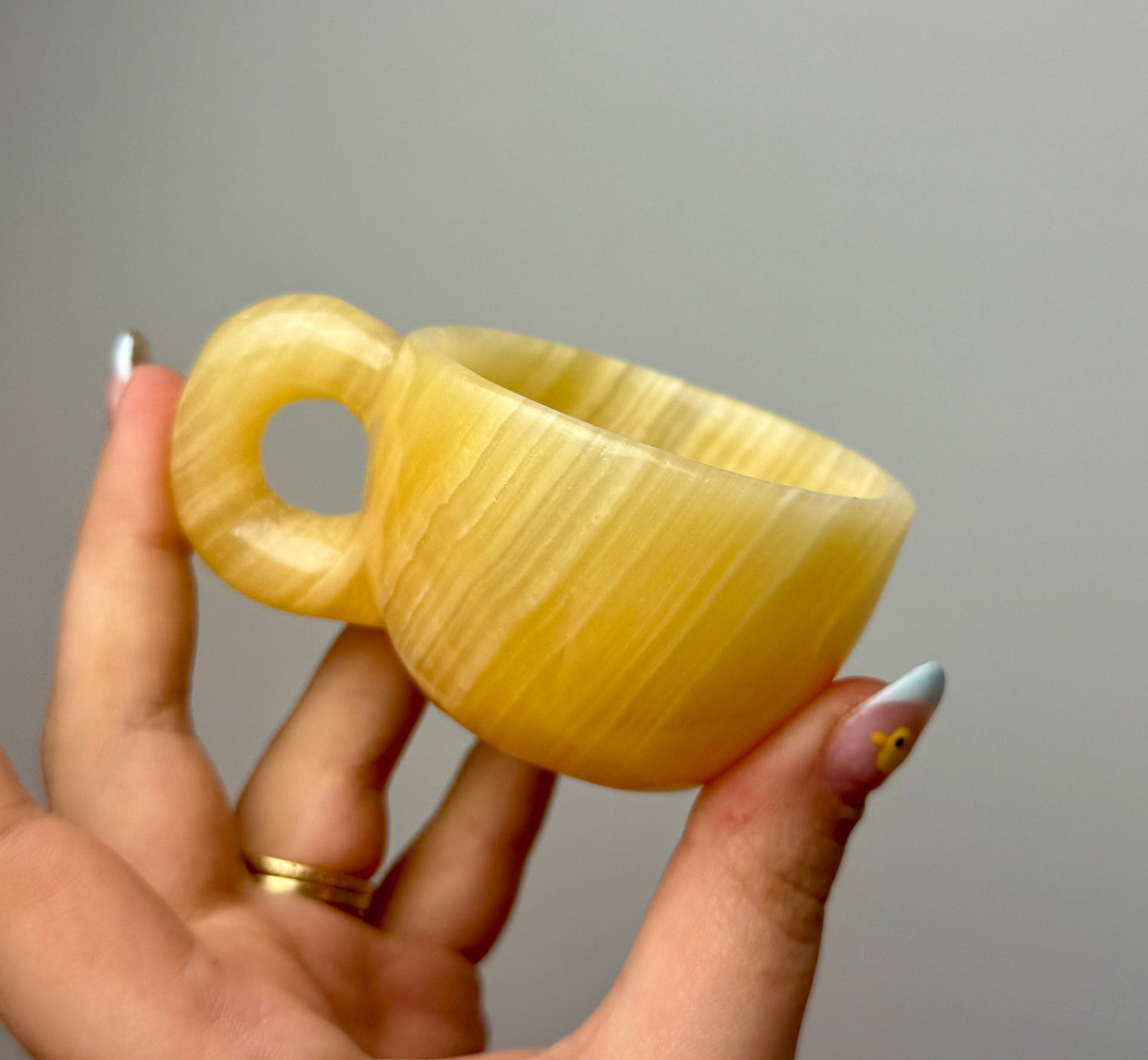 Orange calcite mug/cup carving