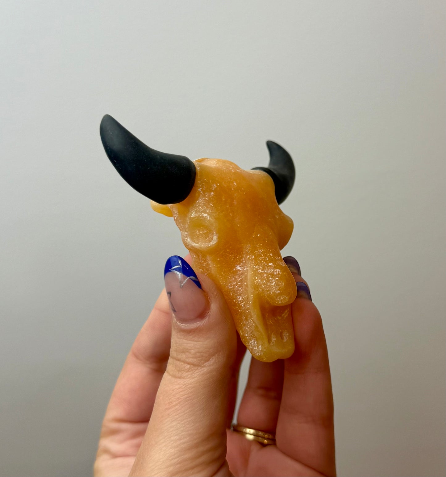 Orange calcite cow skull carving