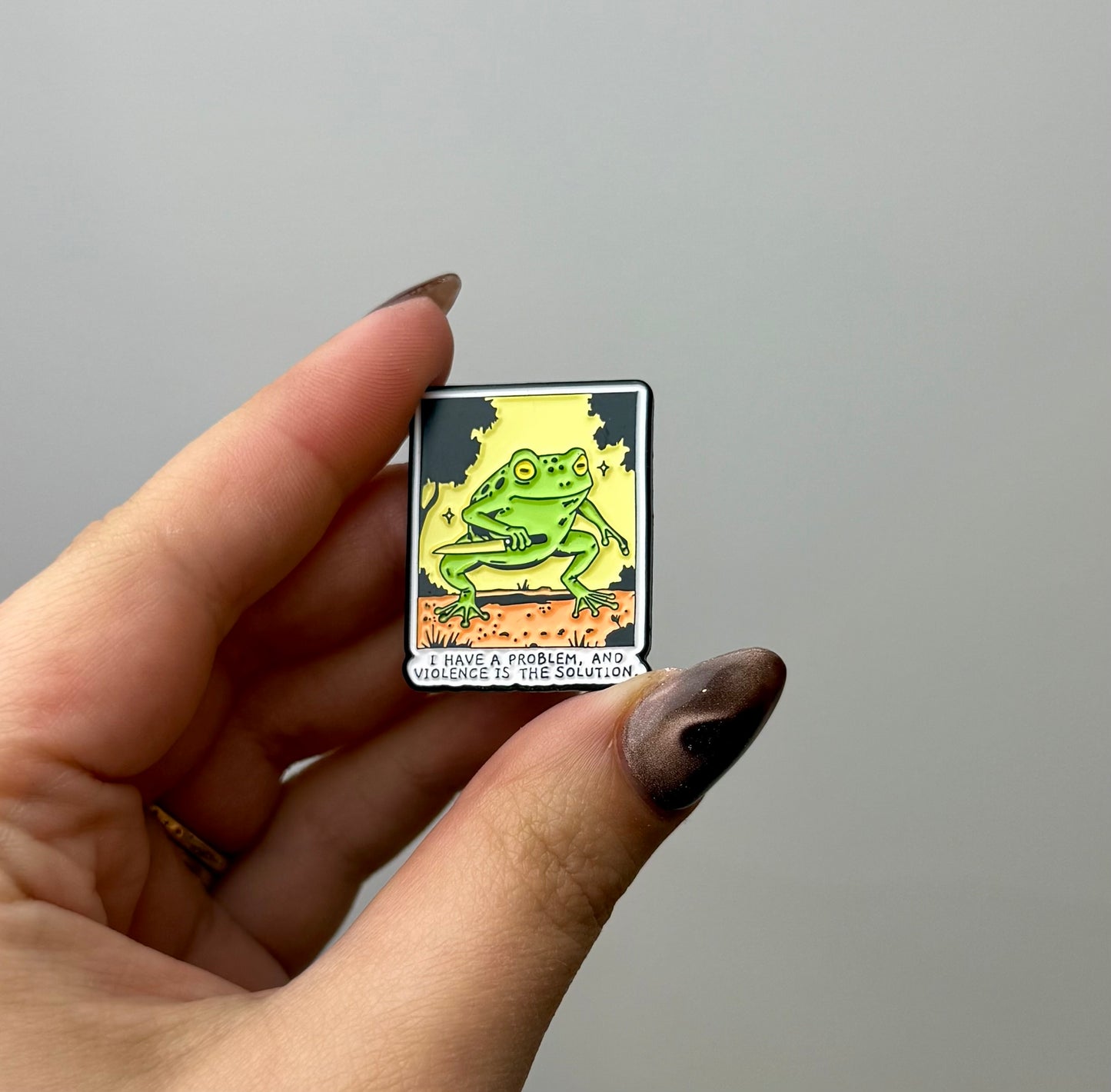 Violence frog enamel pin