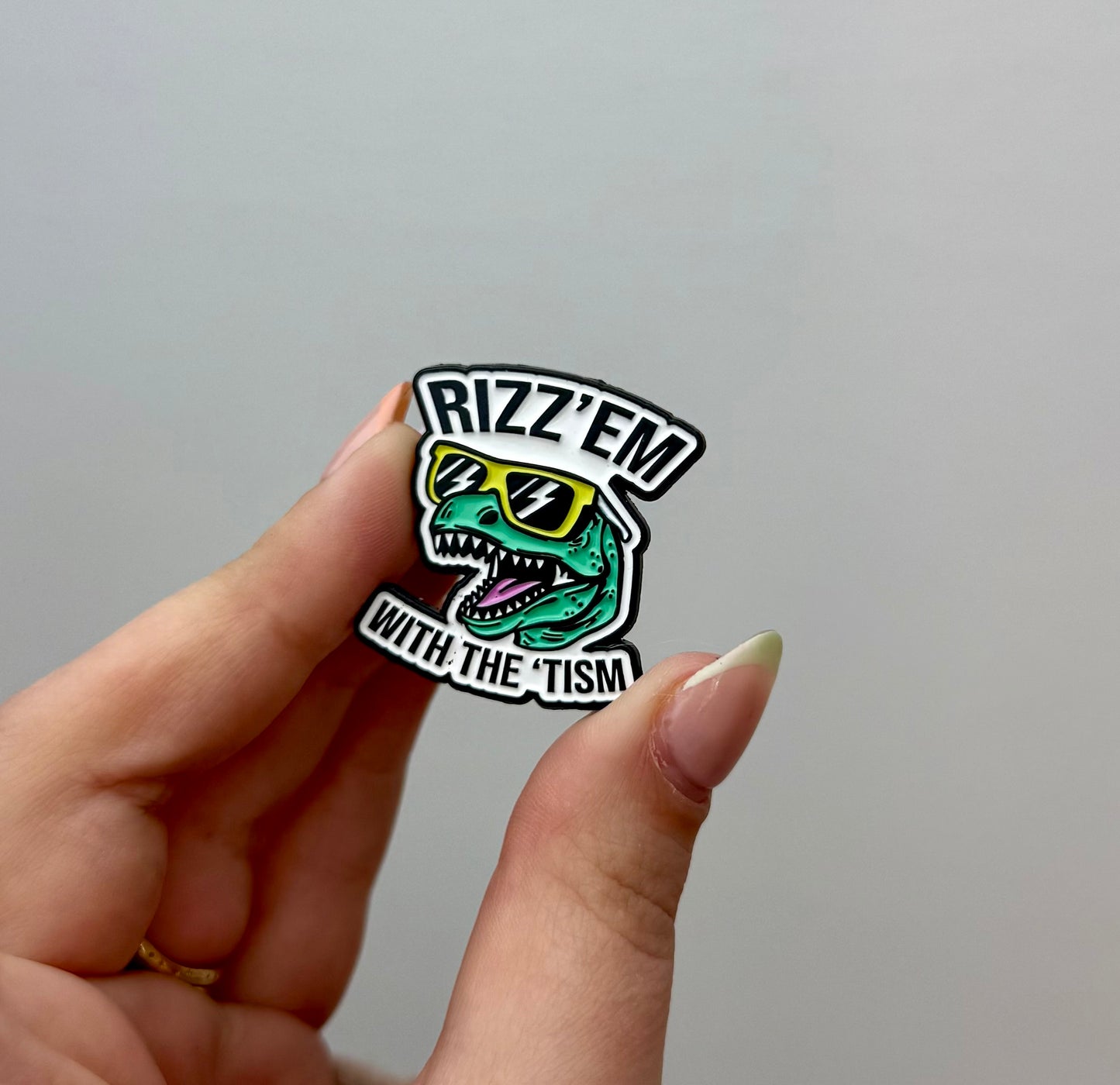 Rizz’em with autism enamel pin