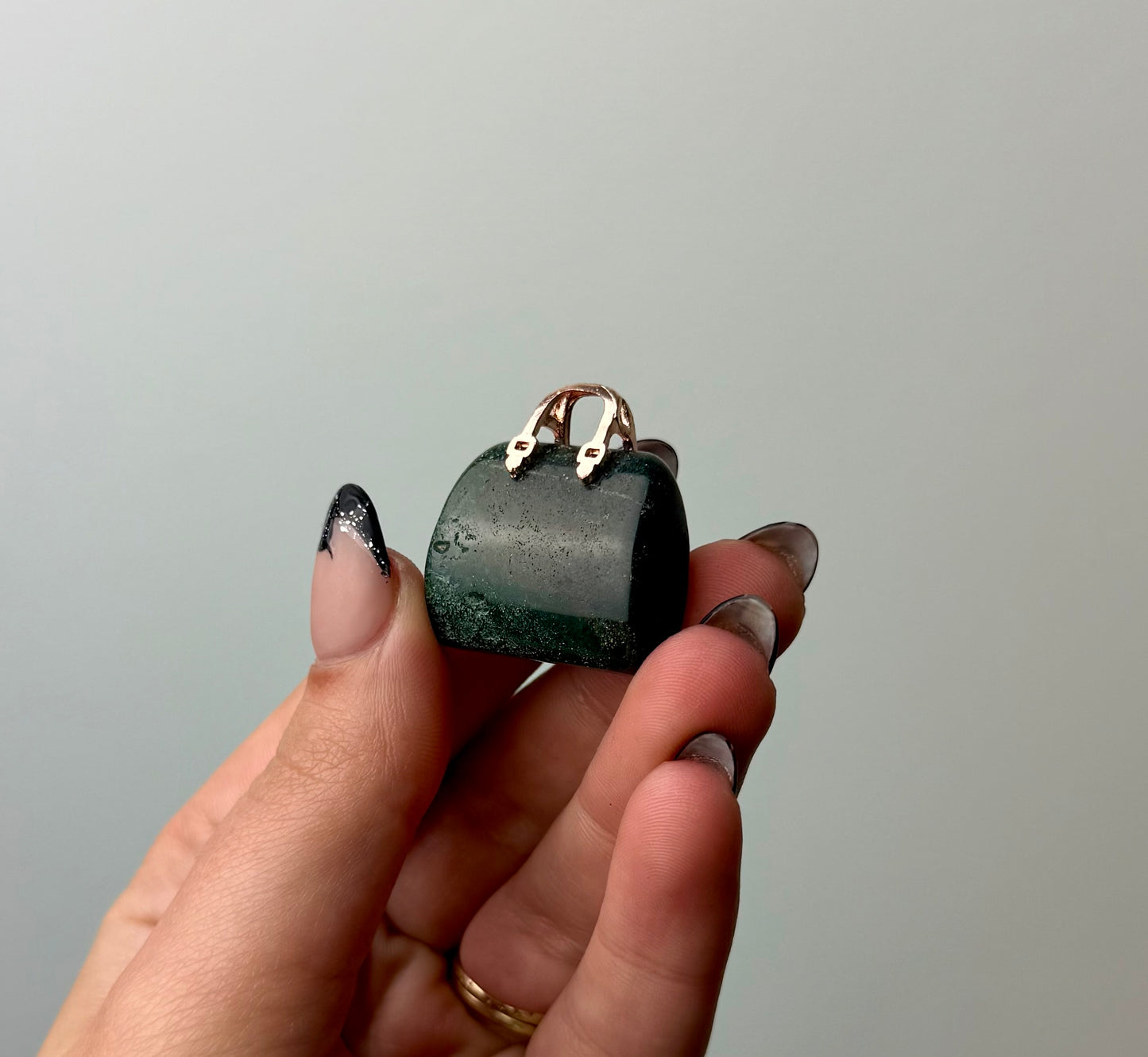 Moss agate purse carving