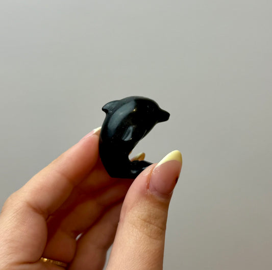 Obsidian dolphin carving