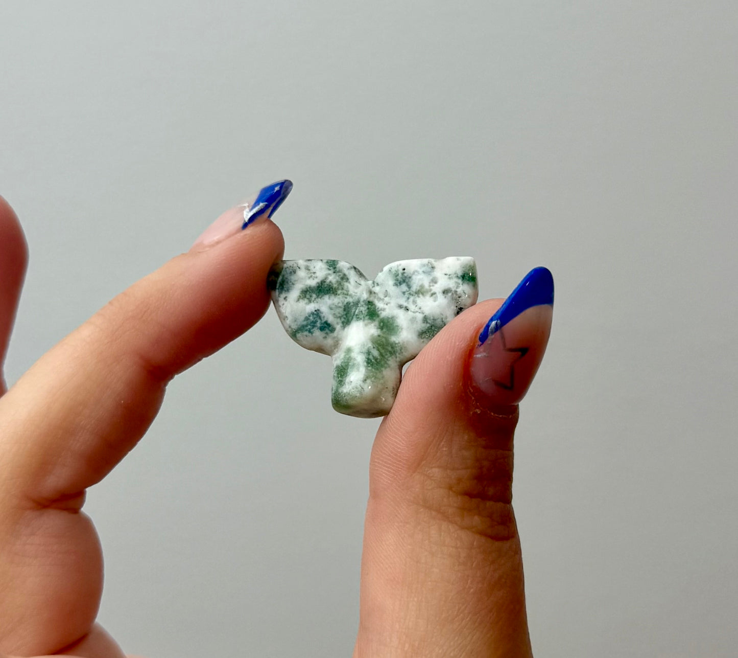 Moss agate whale tail carving