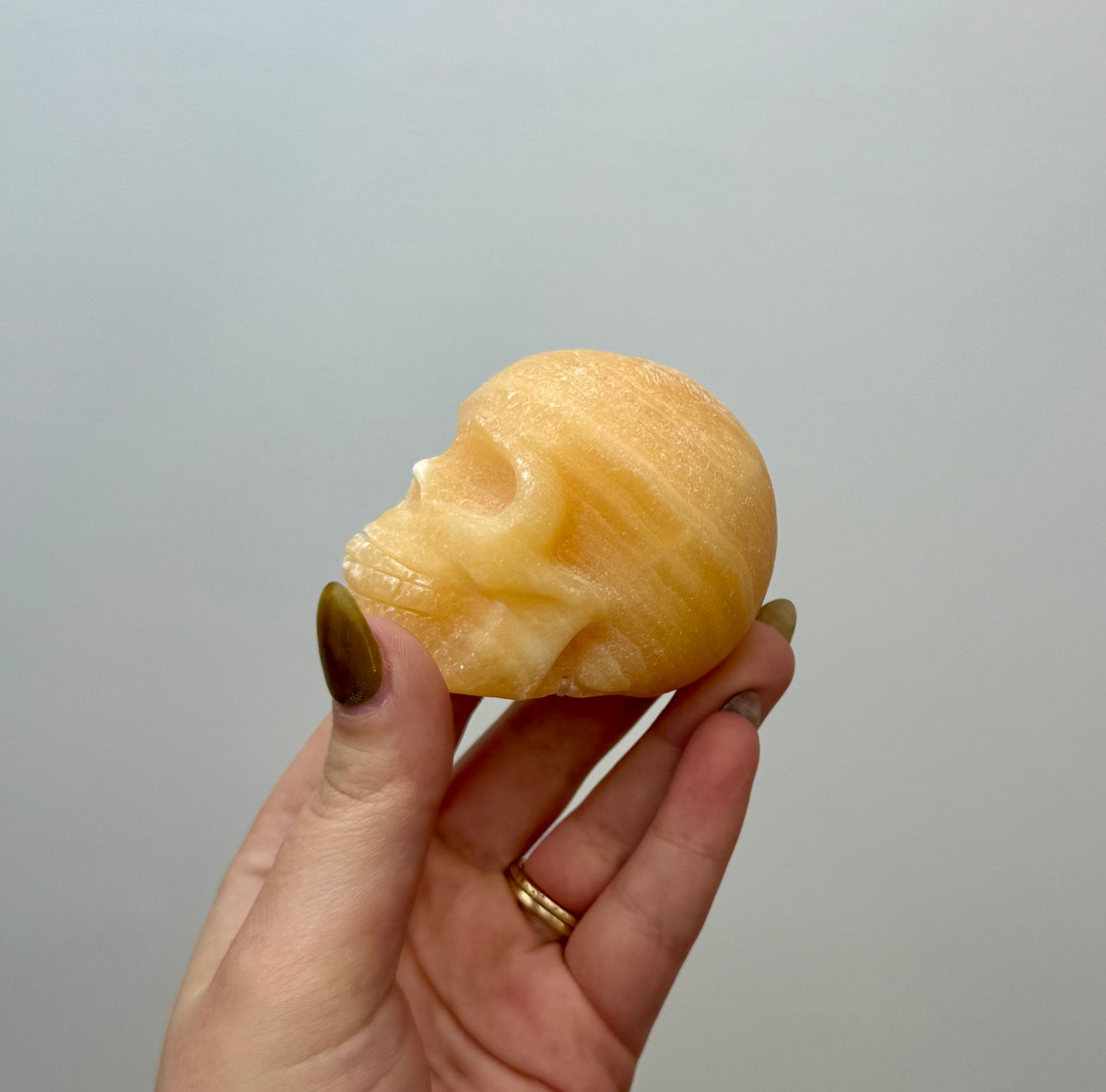 Orange calcite skull carving