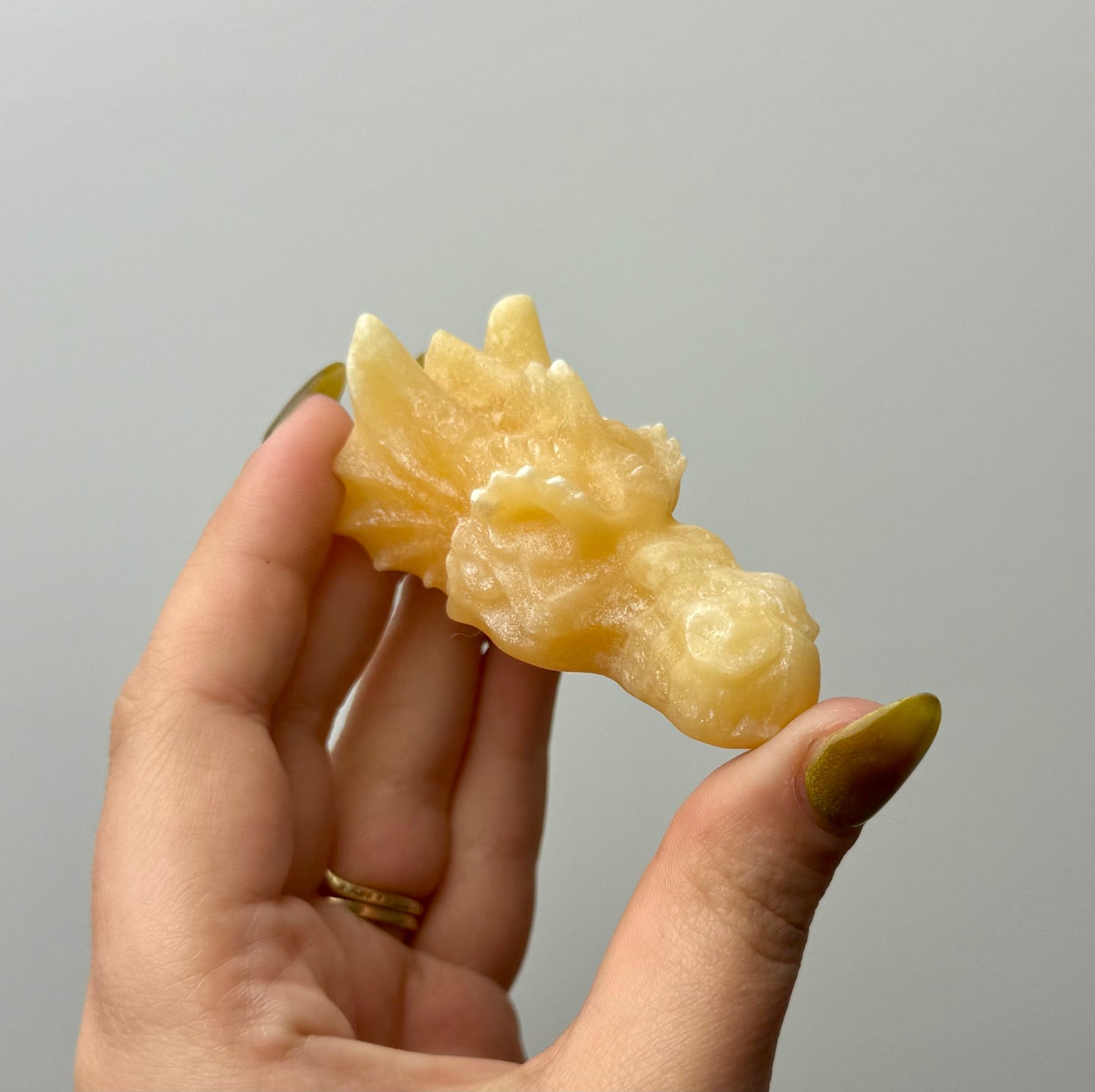 Orange calcite dragon head carving