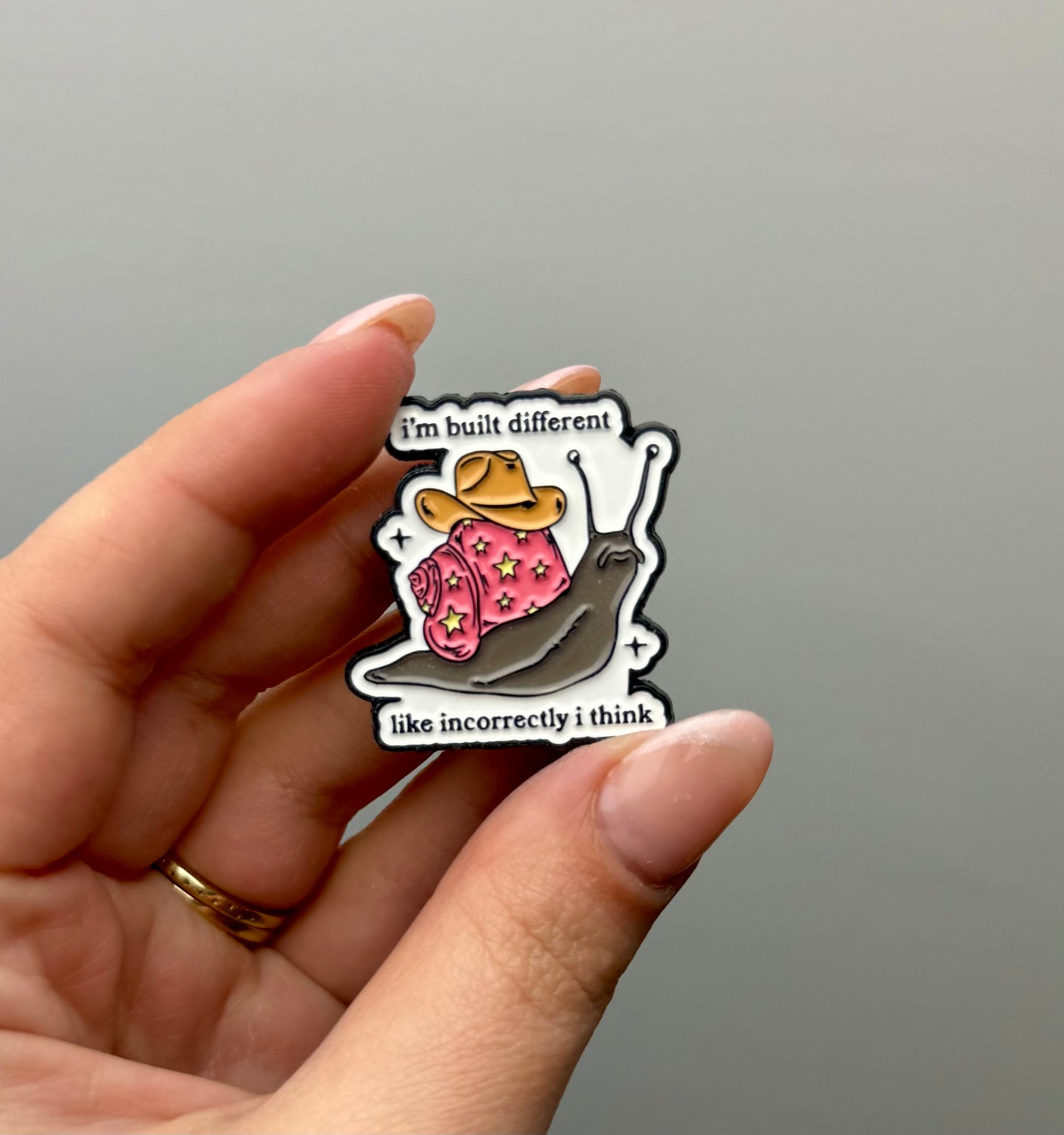 I’m built differently incorrectly snail enamel pin 