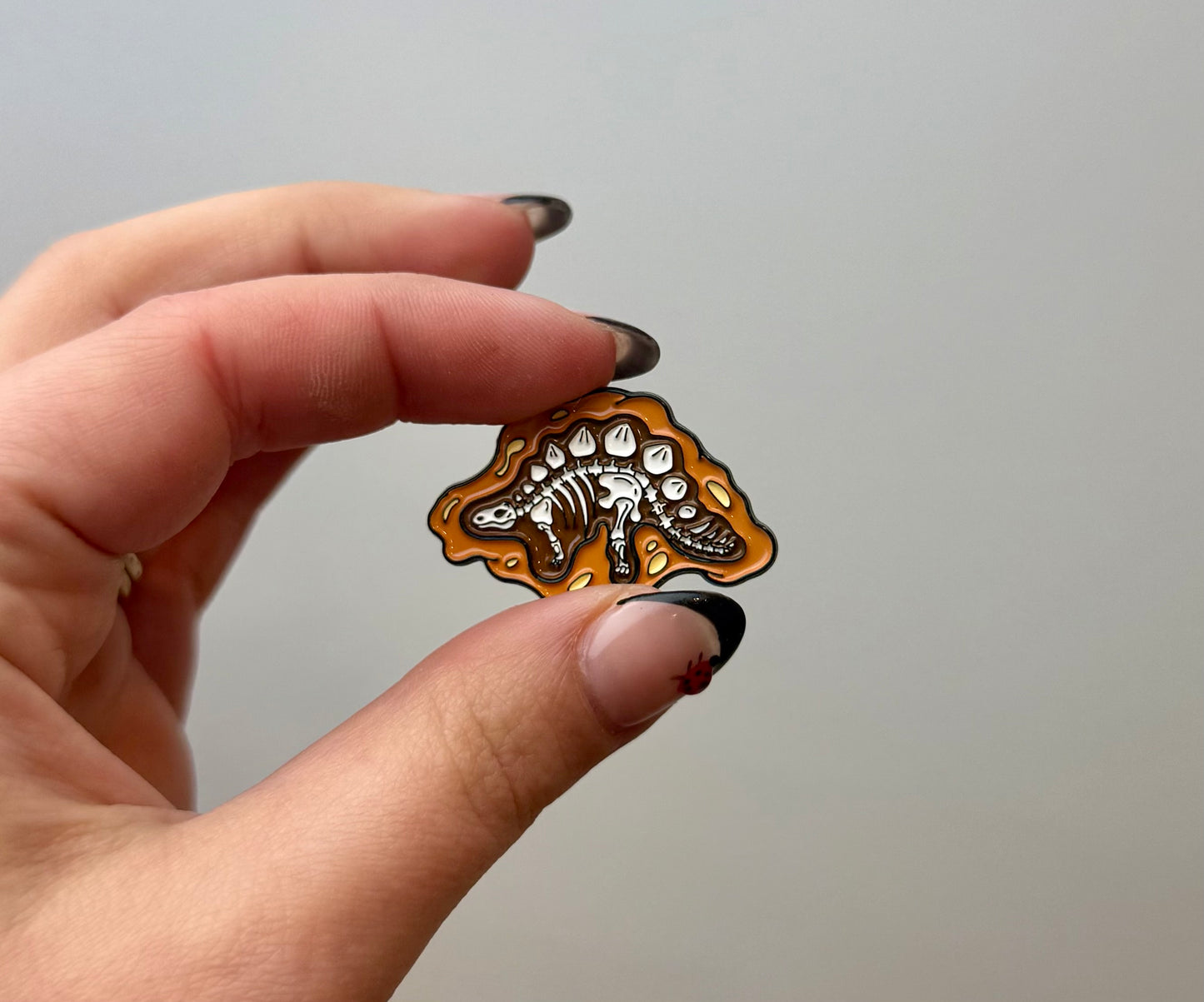 Dinosaur fossil enamel pin