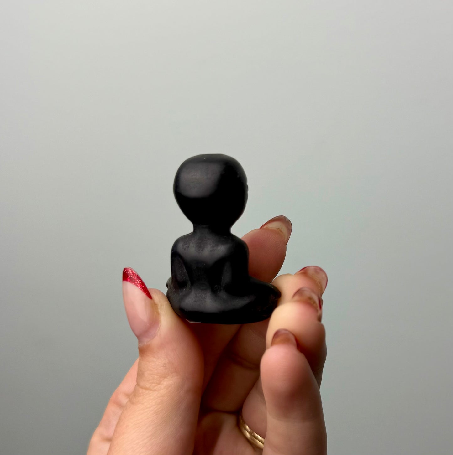 Obsidian alien carving