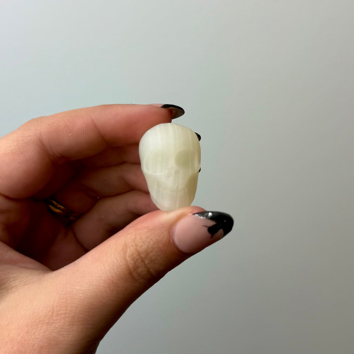 Green calcite “green onyx” skull carving