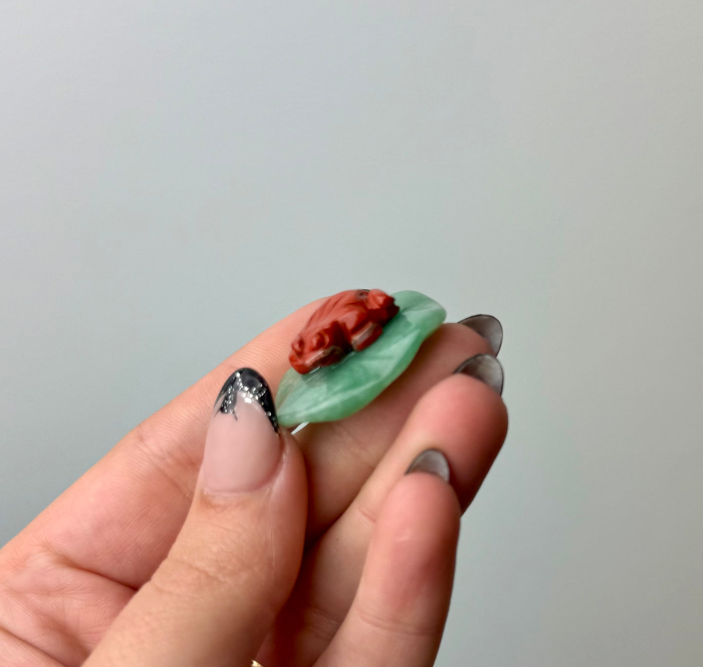 Red jasper frog on lily pad carving