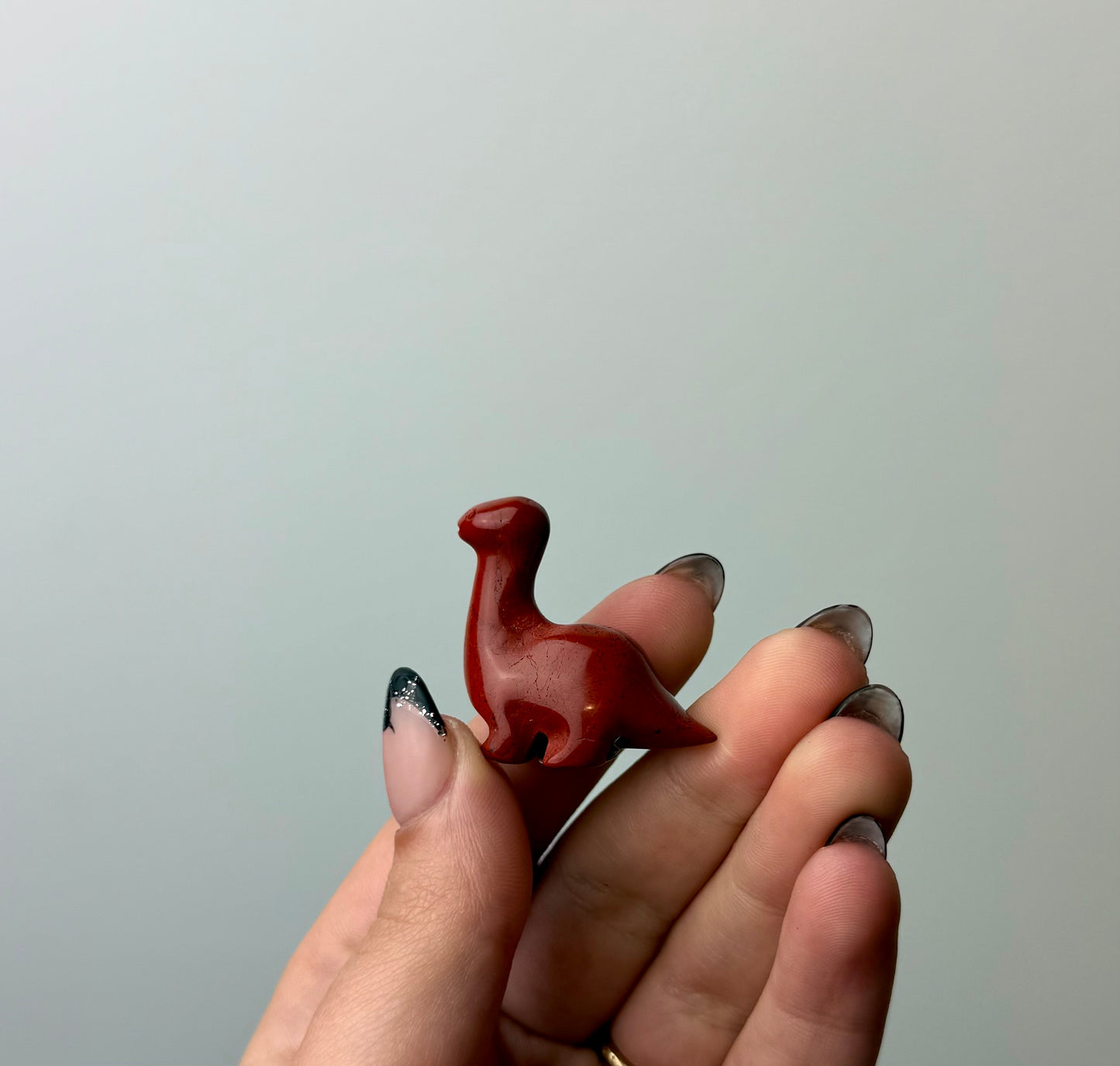 Red jasper dinosaur carving