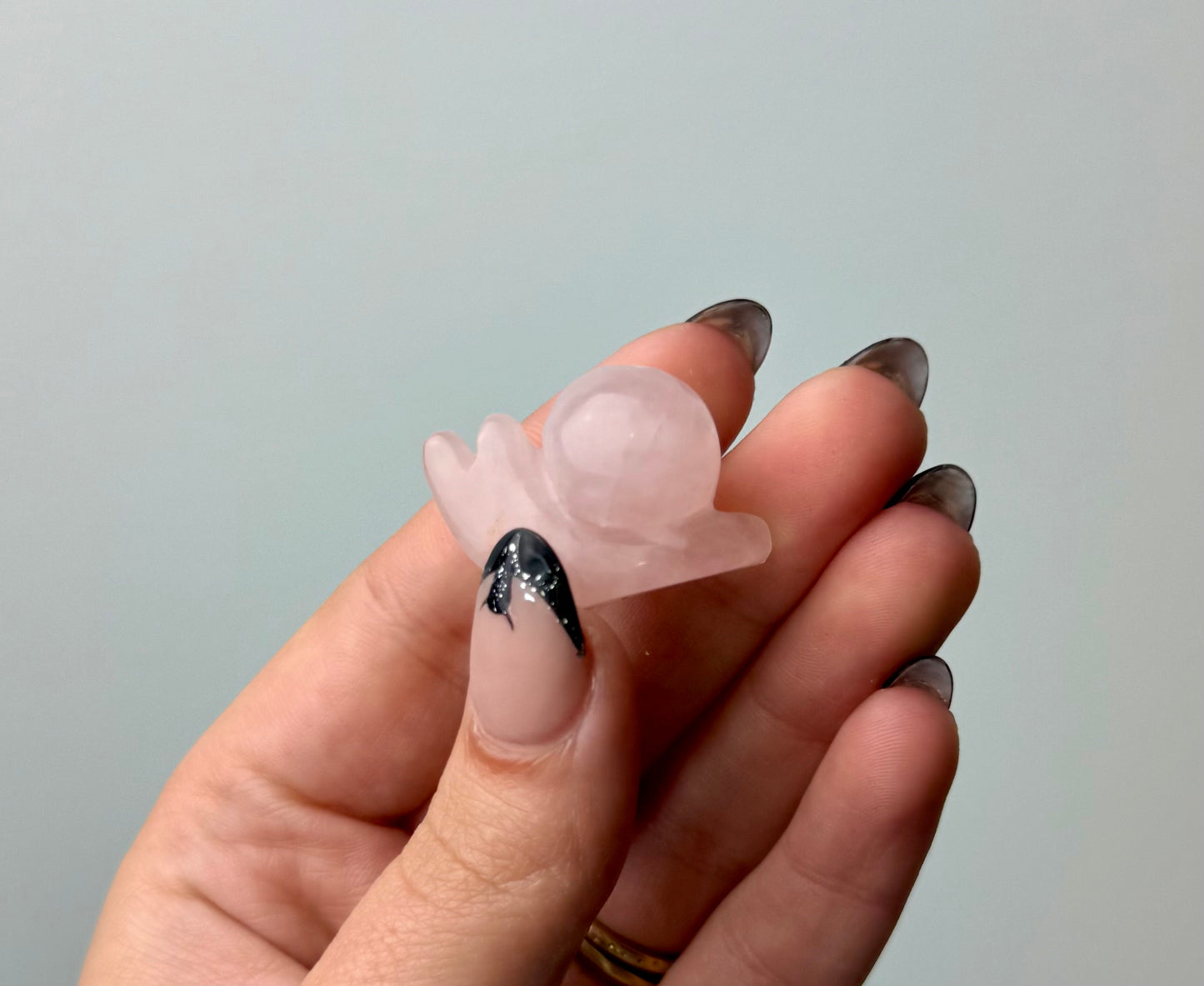 Rose quartz snail carving