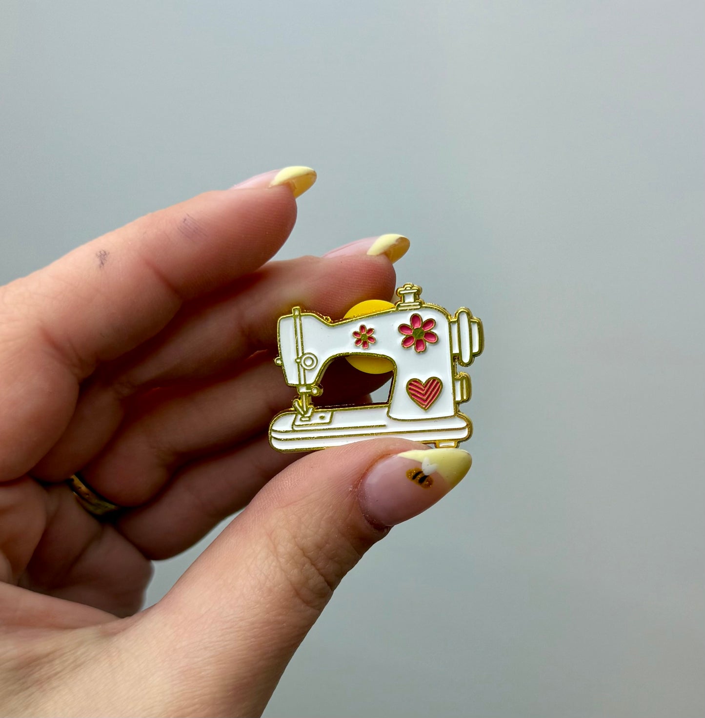 Sewing machine enamel pin