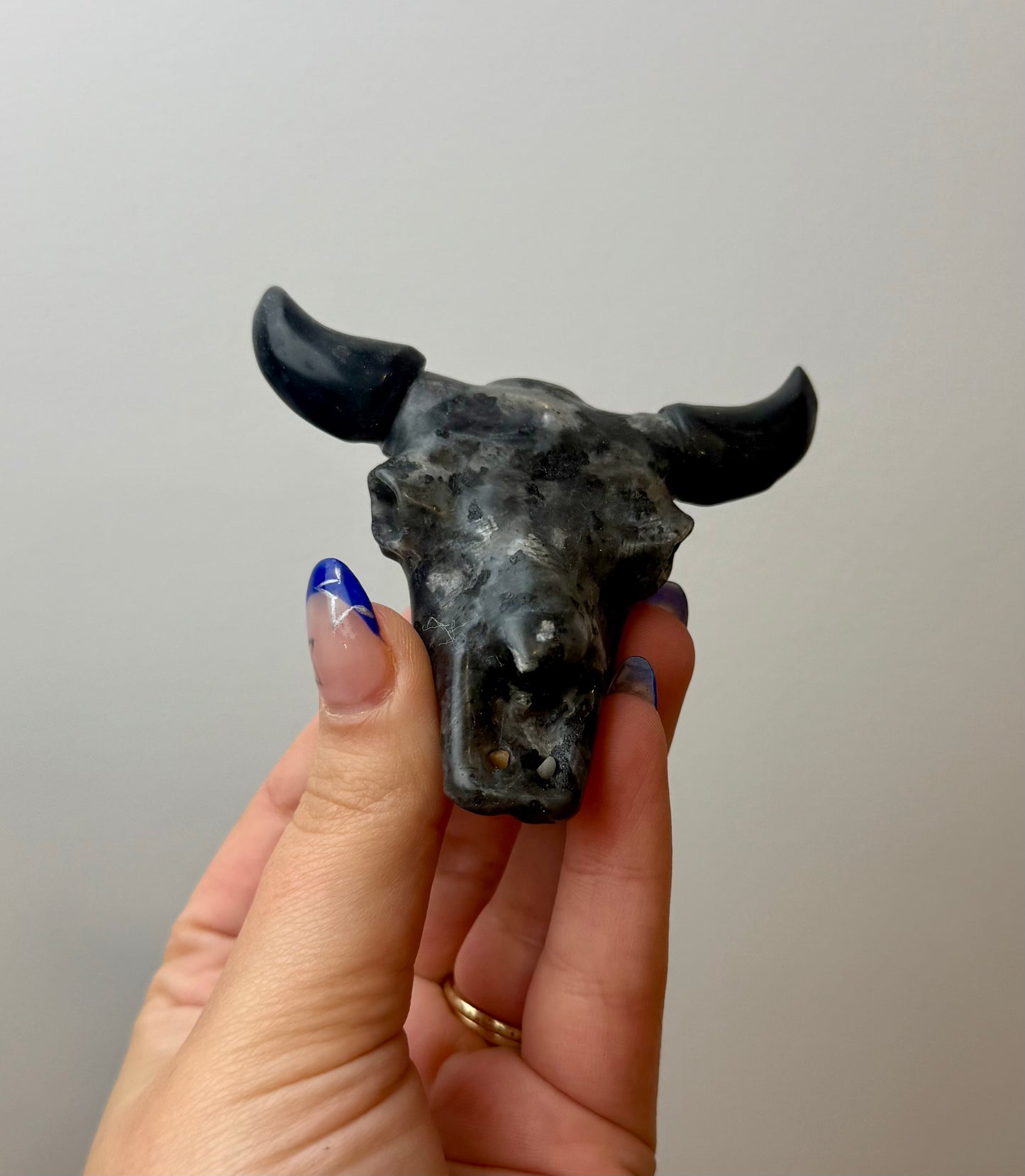 Larvikite cow skull carving