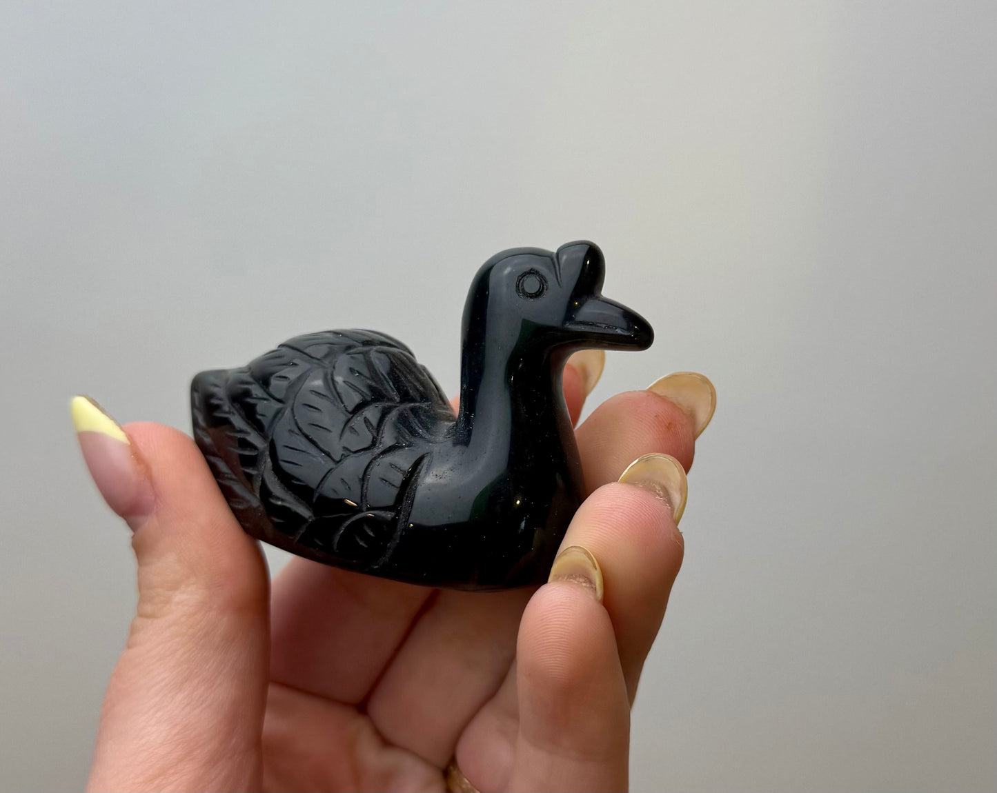 Silver obsidian swan carving