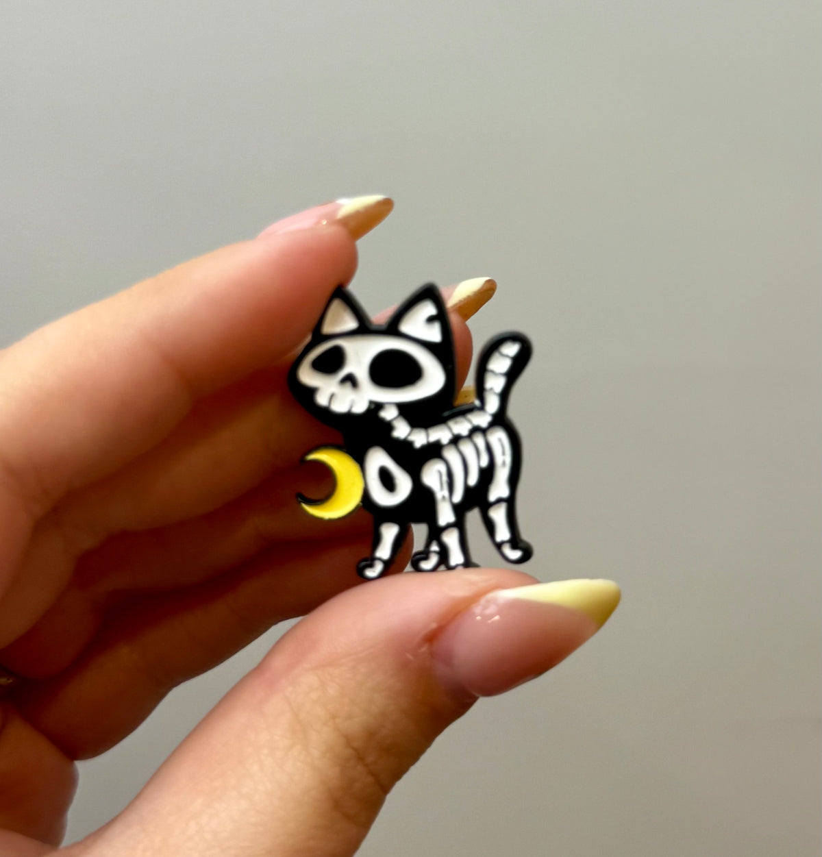 Skelton cat enamel pin