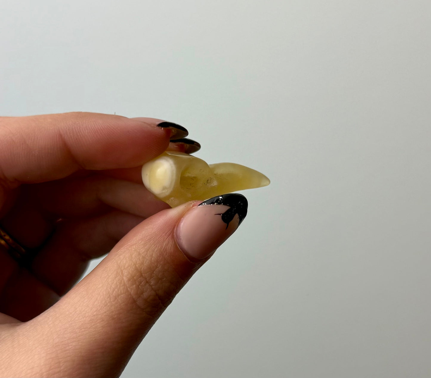 Orange calcite raven head carving