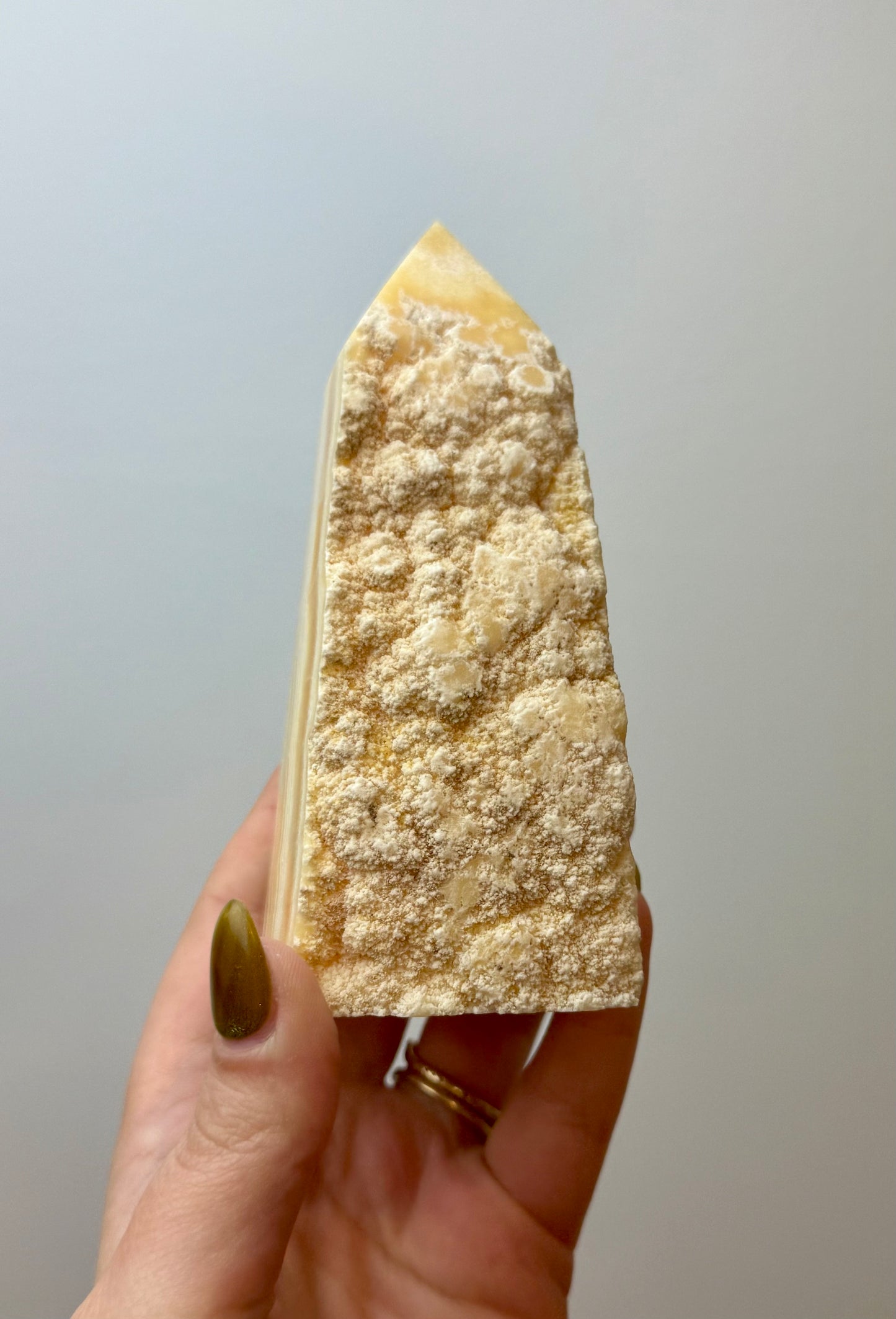 Half raw orange calcite tower