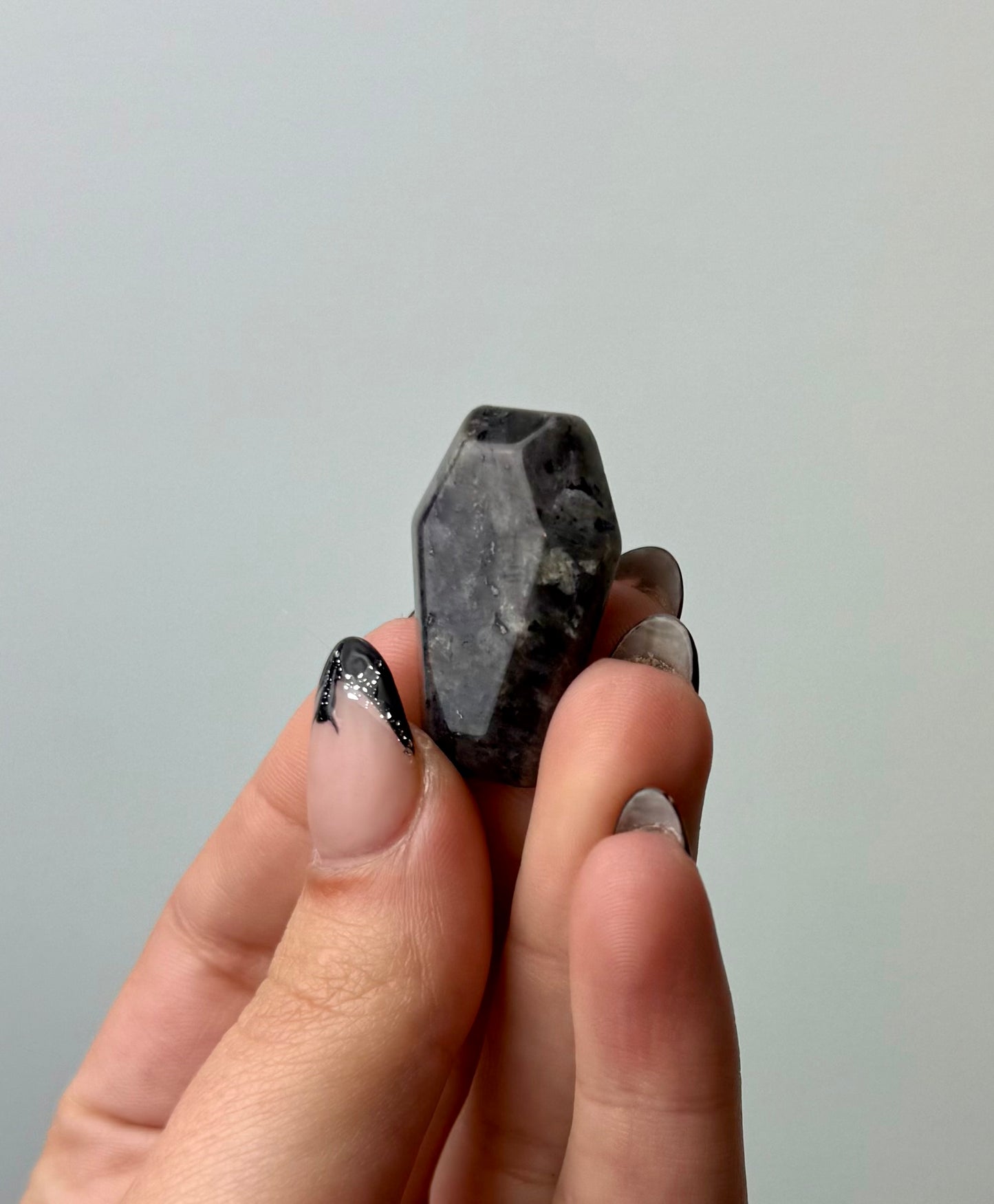 Larvikite coffin carving