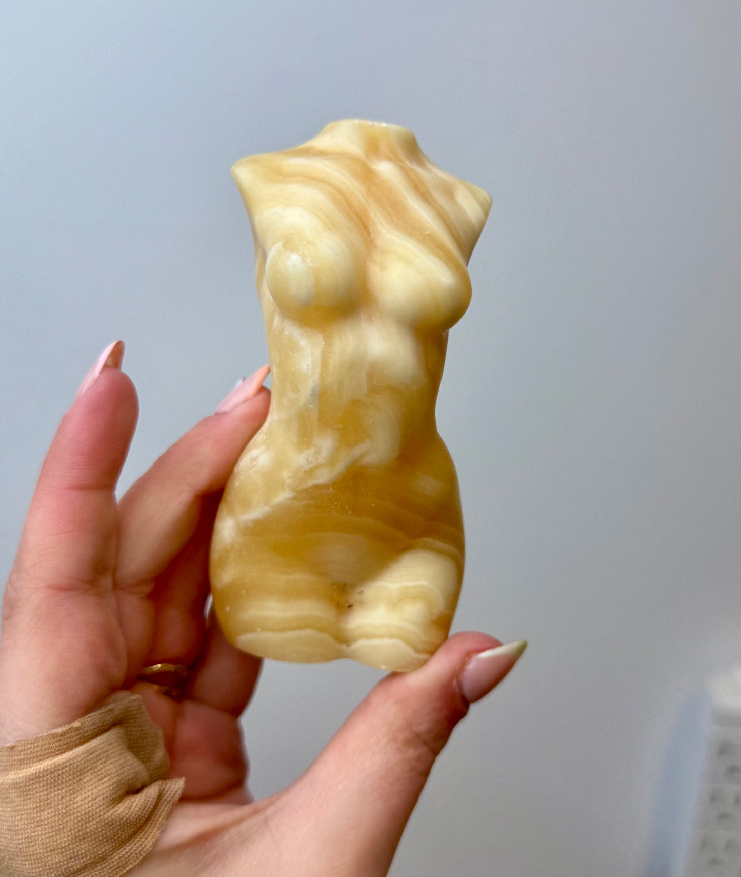 Orange calcite woman body carving