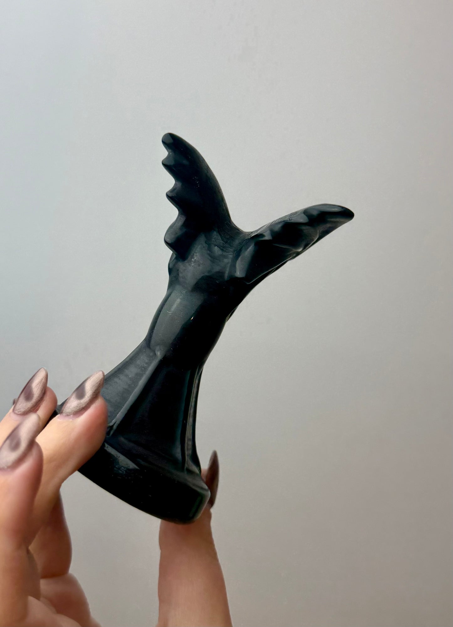 Obsidian bat carving
