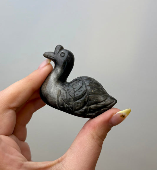Silver obsidian swan carving