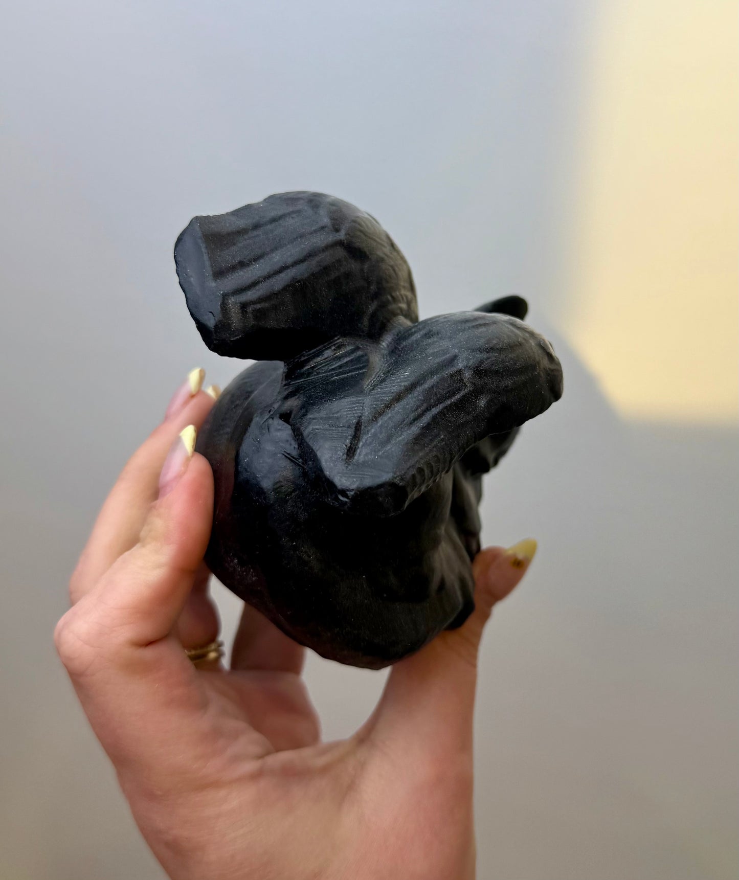 Obsidian angel cat carving