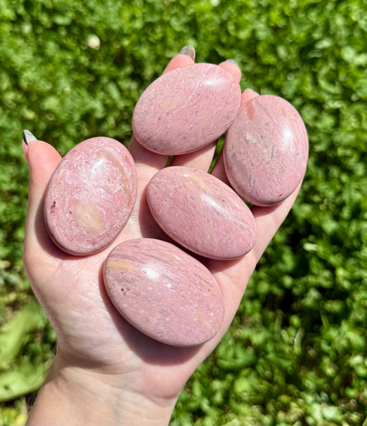 Pink petrified wood palm stones