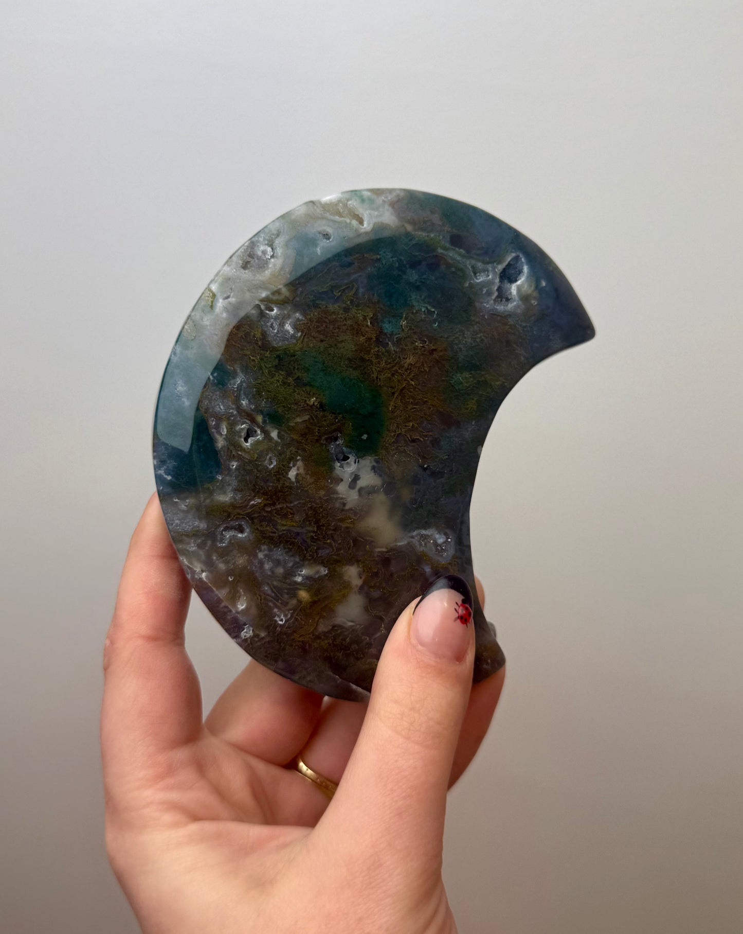 Moss agate moon carving on stand