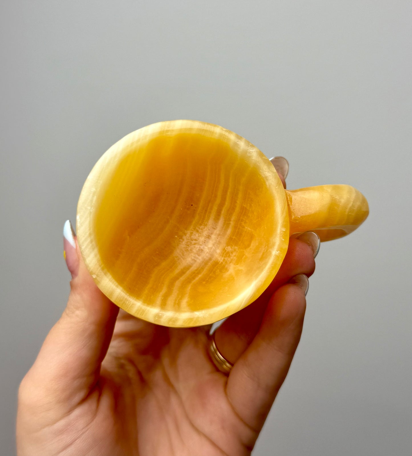 Orange calcite mug/cup carving