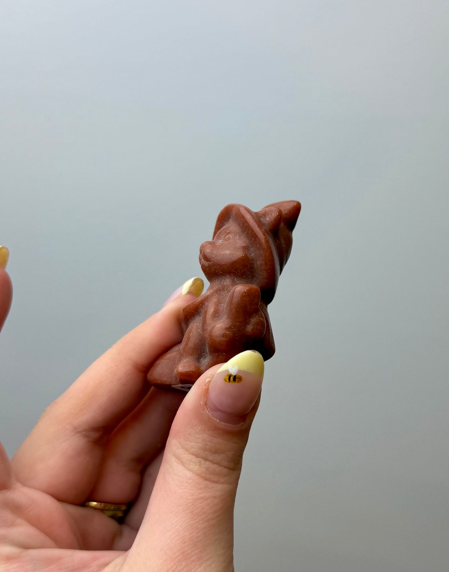Man made material goldstone witch cat carving
