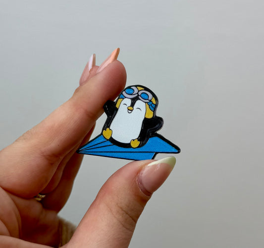 Penguin paper airplane pin