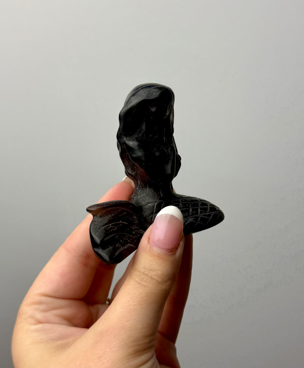 Obsidian mermaid carving