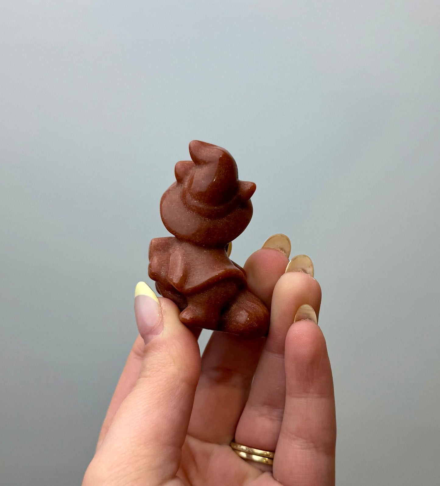 Man made material goldstone witch cat carving