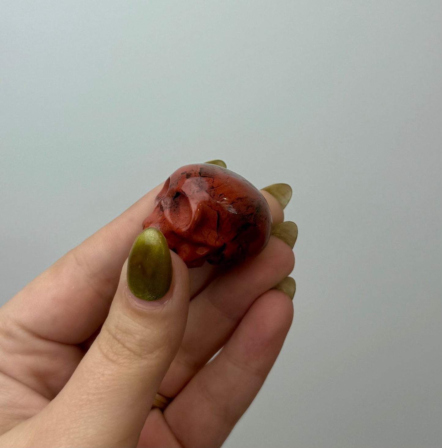 Red jasper skull carving