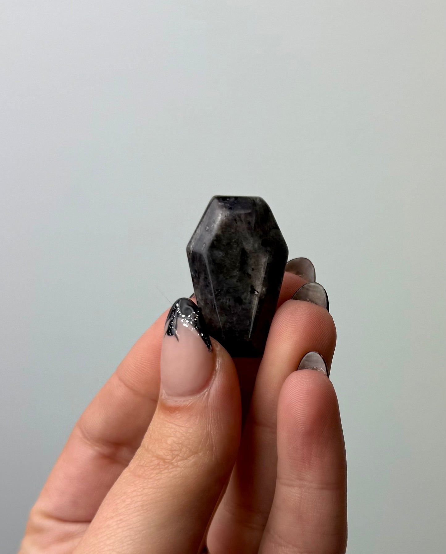 Larvikite coffin carving