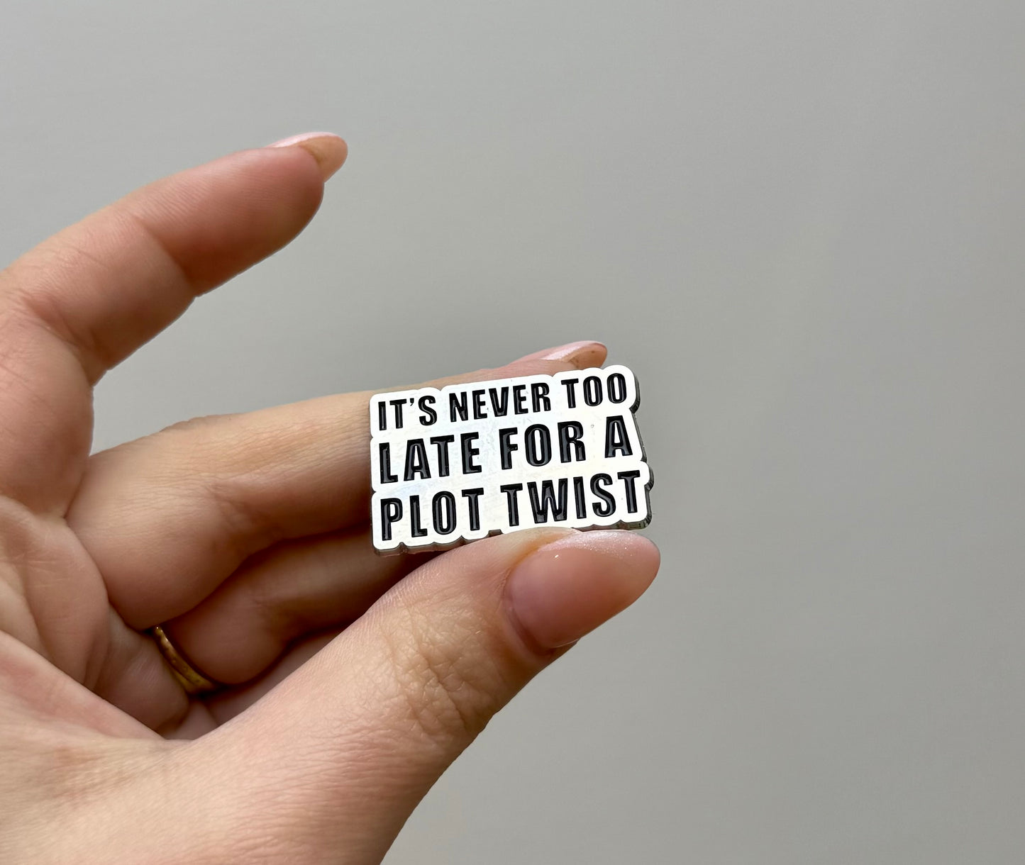 Plot twist enamel pin