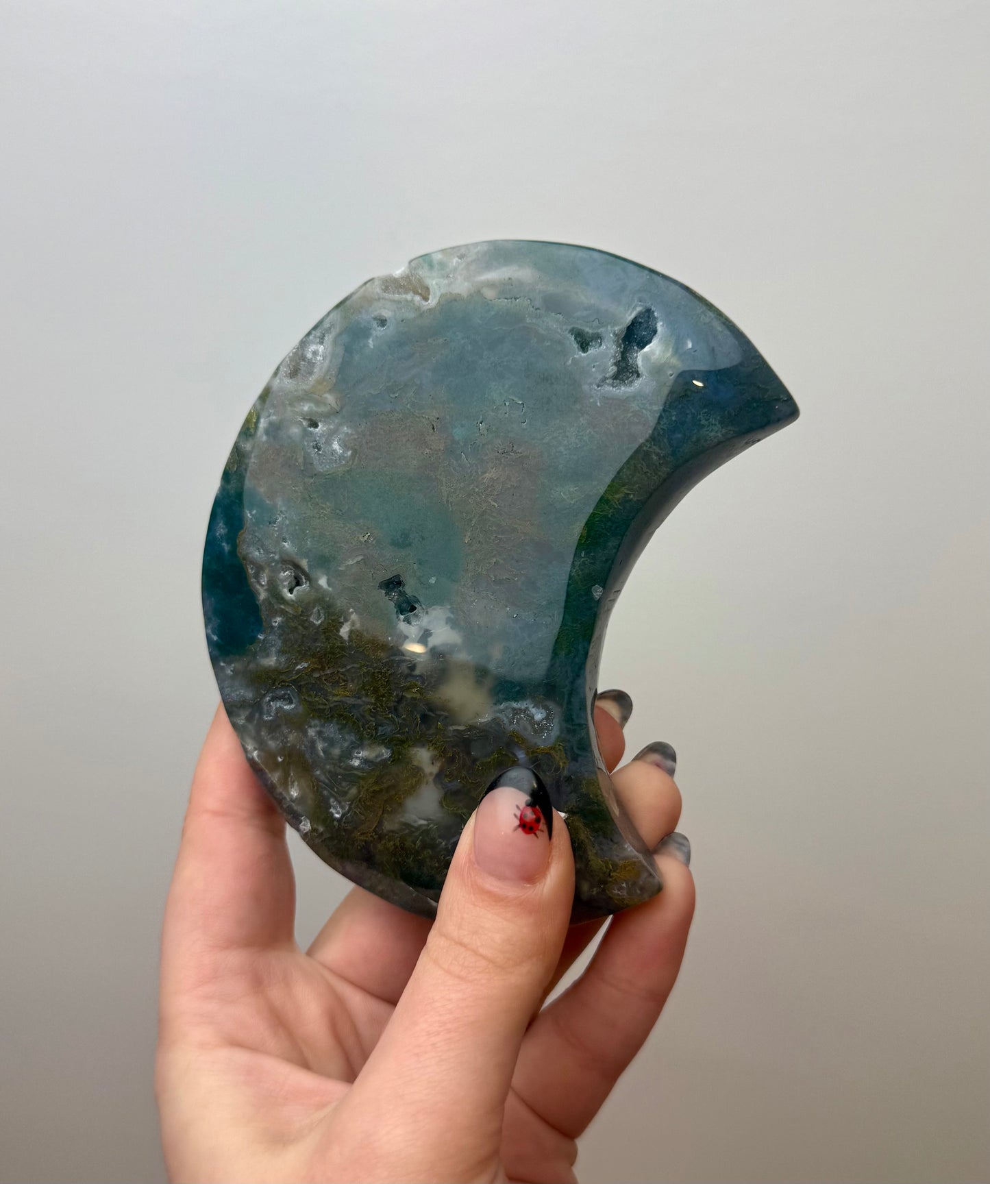 Moss agate moon carving on stand