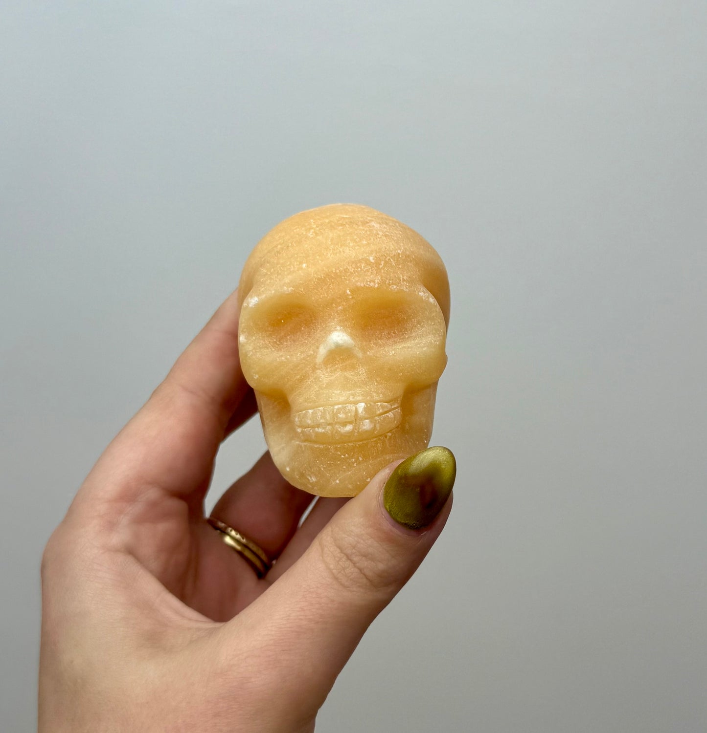 Orange calcite skull carving