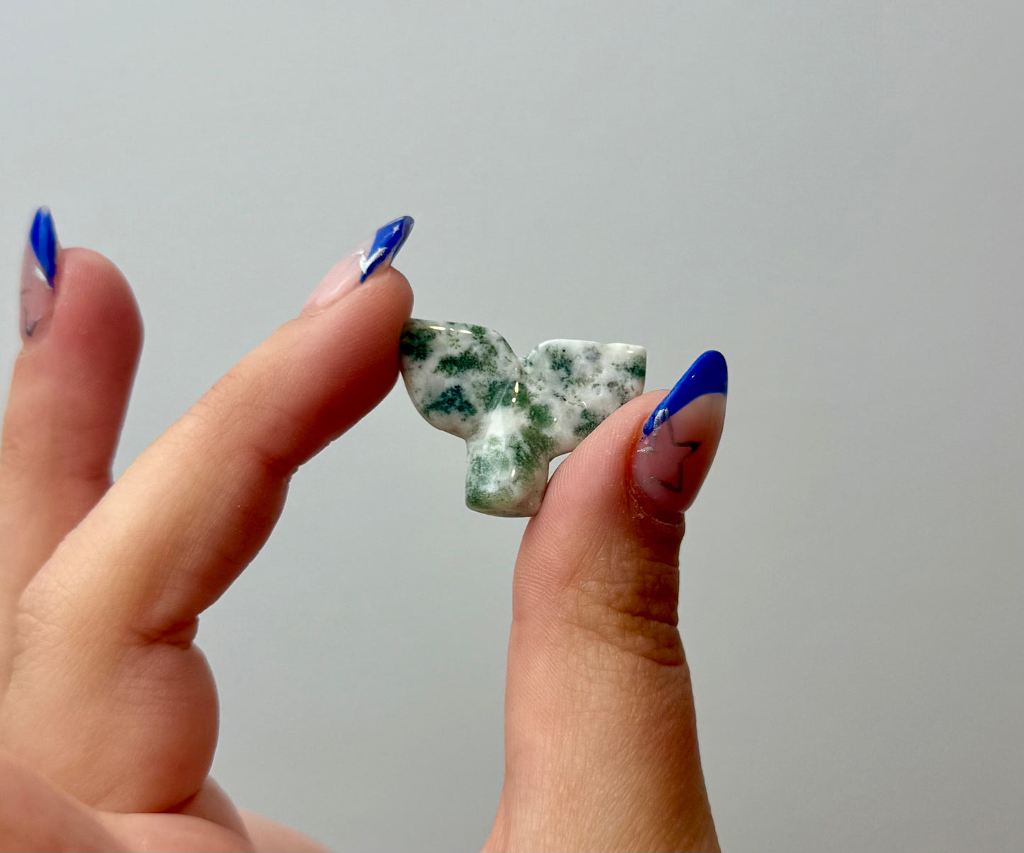 Moss agate whale tail carving
