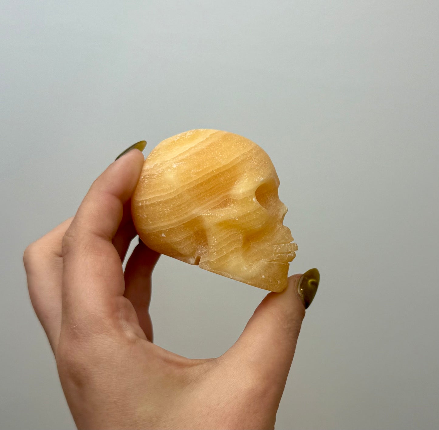 Orange calcite skull carving