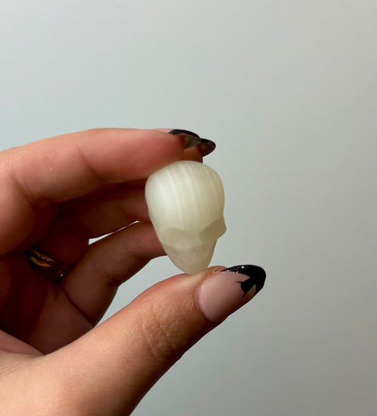 Green calcite “green onyx” skull carving